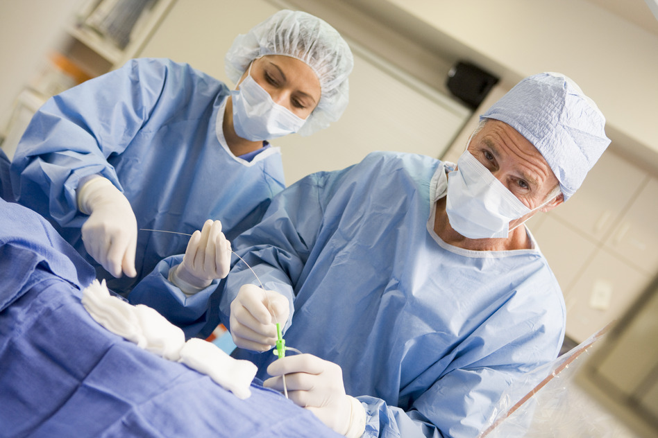 Surgeons Preparing Equipment For Surgery